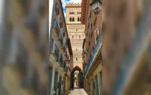 Teruel in Spanien: Mudéjar-Türme, Amantes und Altstadt entdecken Reich verzierter Mudéjar-Turm über einer schmalen Straße in der Altstadt von Teruel